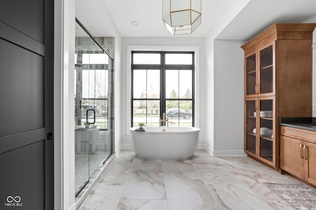 bathroom featuring vanity and independent shower and bath