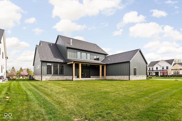 back of property featuring a yard and central AC unit