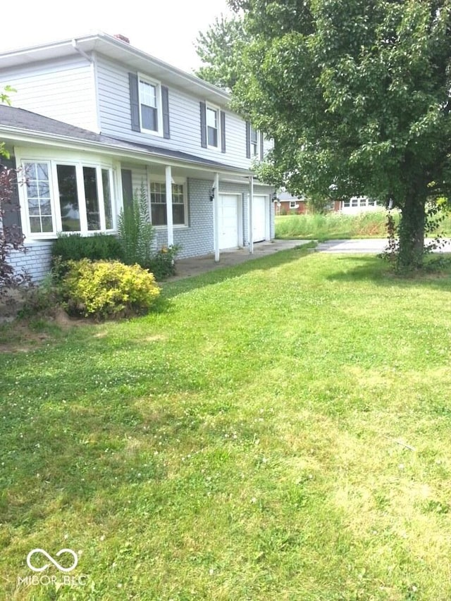 exterior space with a garage and a front lawn