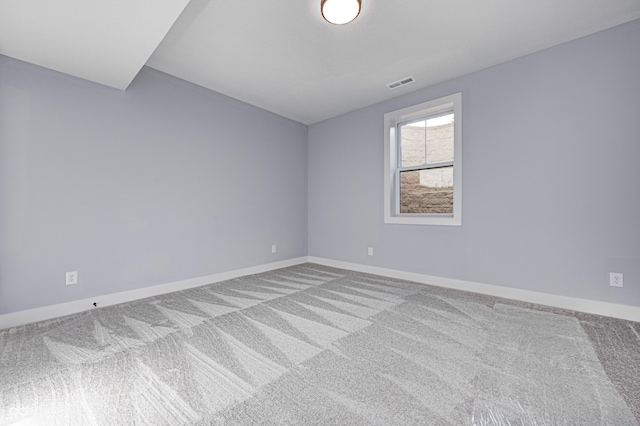 spare room featuring light carpet