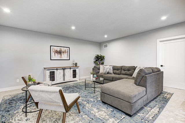 living room with a textured ceiling and light carpet