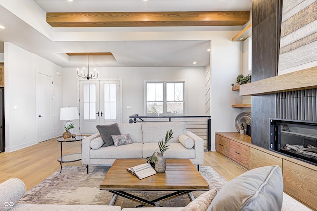 16298 Grand Cypress Dr, Noblesville, IN 46060 - living area featuring light wood-style floors, a chandelier, recessed lighting, beamed ceiling, and a raised ceiling