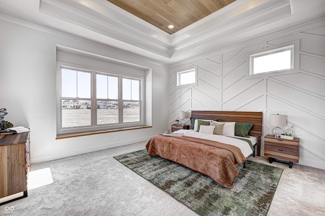 carpeted bedroom featuring a raised ceiling and crown molding