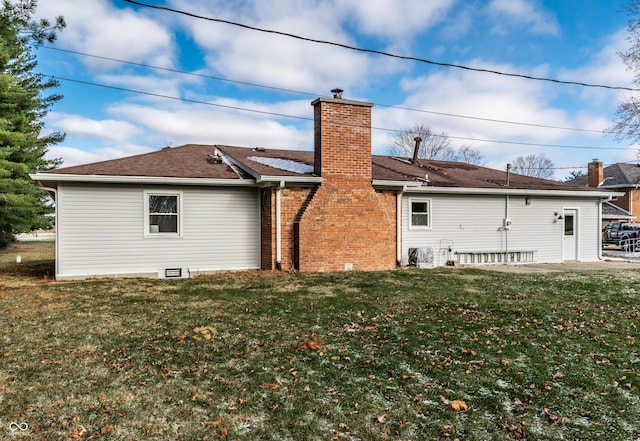 back of property featuring a patio area and a yard