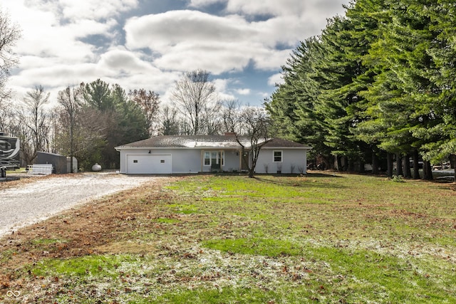 view of front of property featuring a garage and a front lawn