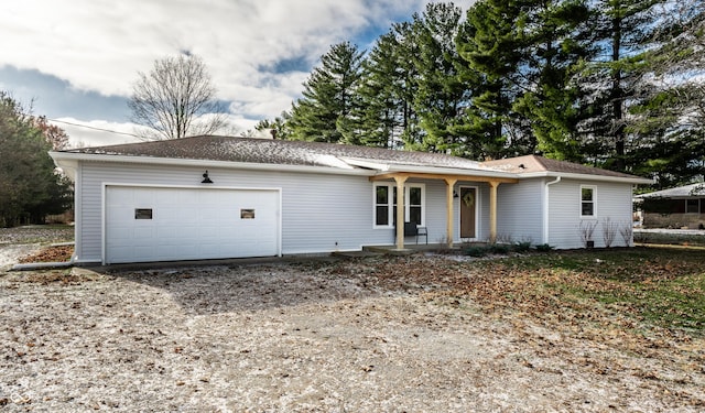 single story home with covered porch and a garage