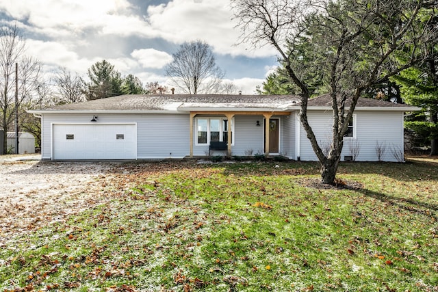 ranch-style home with a garage and a front lawn