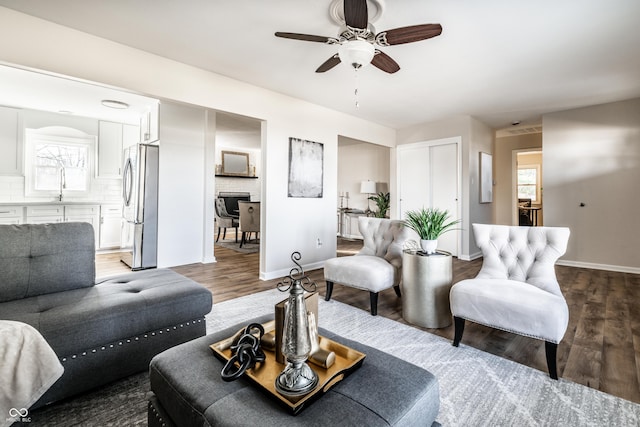 living room featuring ceiling fan, dark hardwood / wood-style flooring, and sink