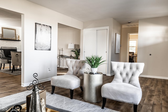 living area featuring a fireplace and dark hardwood / wood-style flooring