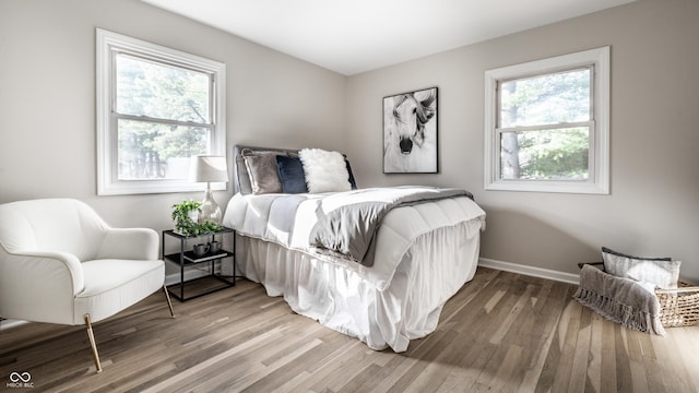 bedroom featuring hardwood / wood-style floors and multiple windows