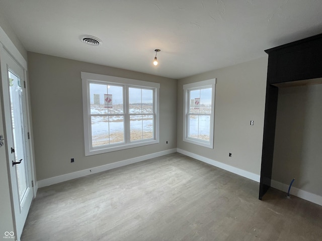 unfurnished dining area featuring hardwood / wood-style flooring