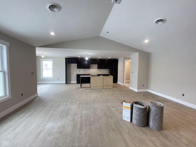 unfurnished living room with lofted ceiling and wood-type flooring