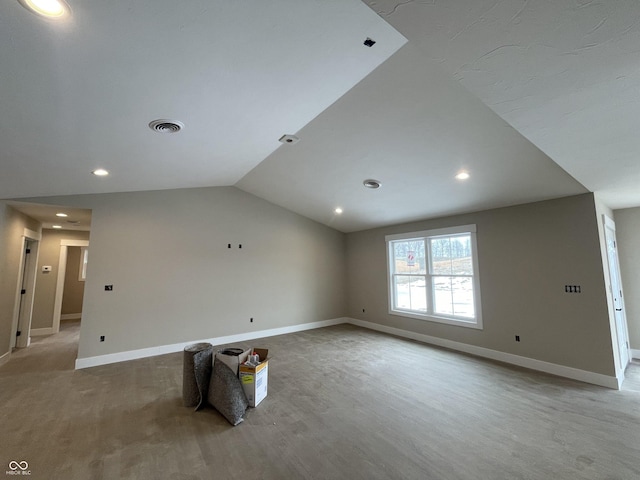 unfurnished room with vaulted ceiling and light wood-type flooring