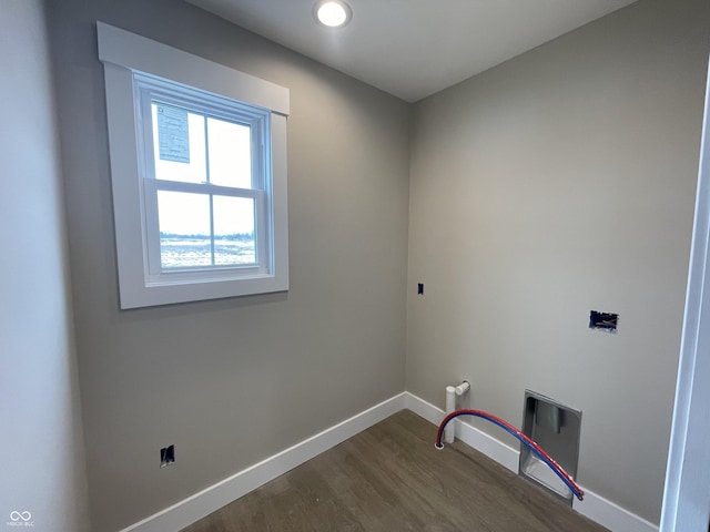 clothes washing area with hardwood / wood-style floors