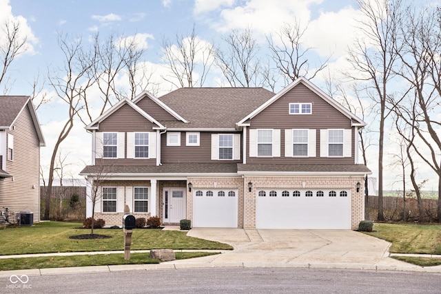 view of front of property with cooling unit, a front yard, and a garage