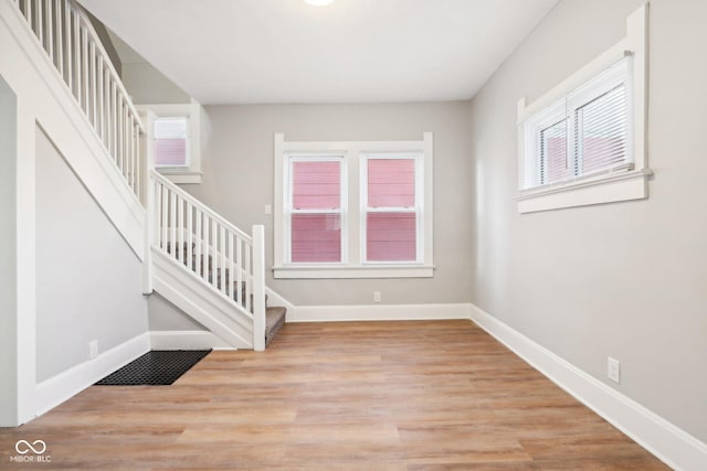 staircase with hardwood / wood-style floors