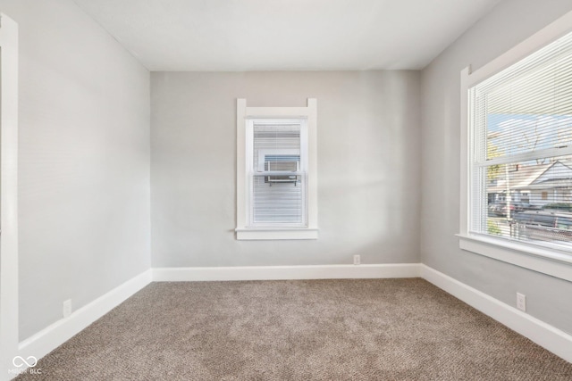 carpeted spare room with a healthy amount of sunlight