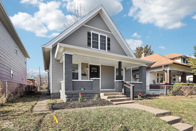 bungalow with a porch and a front yard