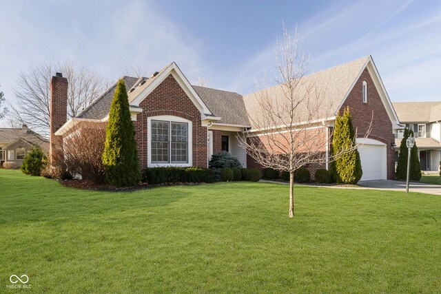 view of front facade with a front yard and a garage