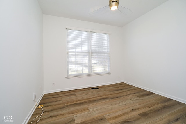 unfurnished room with ceiling fan and hardwood / wood-style floors