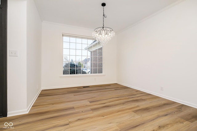 unfurnished dining area with a notable chandelier, crown molding, and hardwood / wood-style flooring