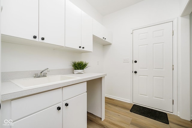 washroom with light wood-type flooring and sink