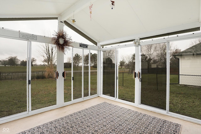 unfurnished sunroom with vaulted ceiling with beams and plenty of natural light