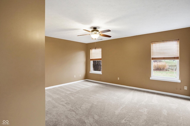 spare room with light carpet and ceiling fan