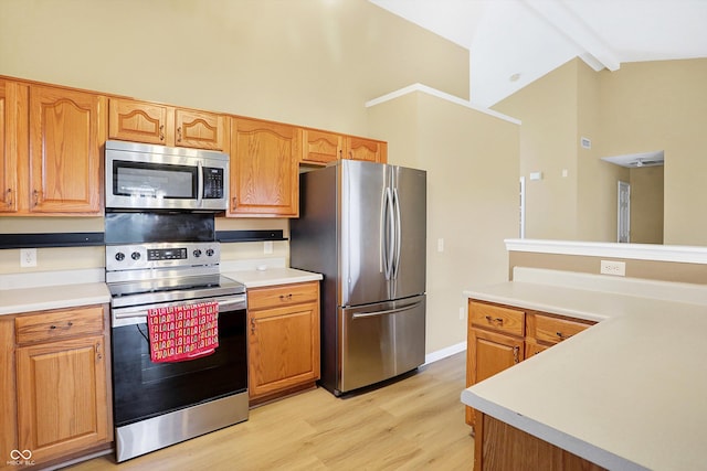 kitchen with beam ceiling, light hardwood / wood-style flooring, high vaulted ceiling, and appliances with stainless steel finishes