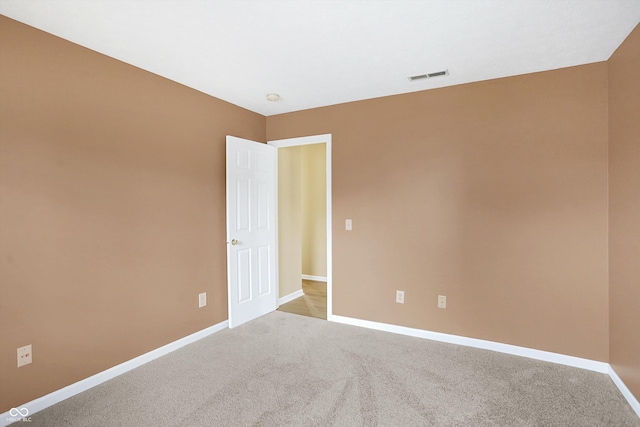 unfurnished room with light colored carpet