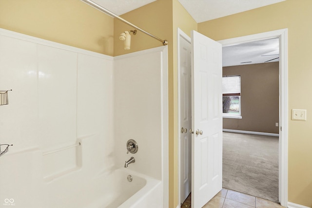 bathroom with shower / tub combination, ceiling fan, and tile patterned flooring