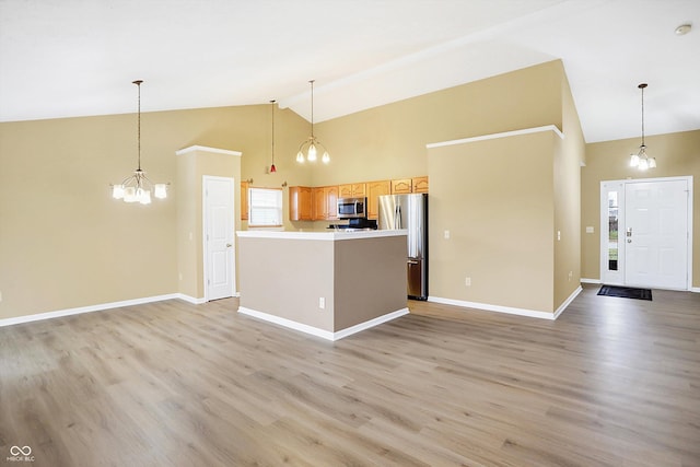 kitchen featuring appliances with stainless steel finishes, light hardwood / wood-style floors, and pendant lighting