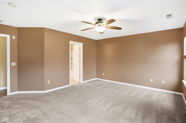 empty room featuring ceiling fan and light carpet