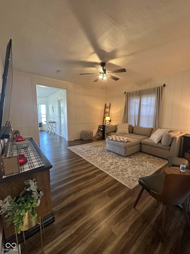 living room with wood-type flooring, a textured ceiling, ceiling fan, and a healthy amount of sunlight