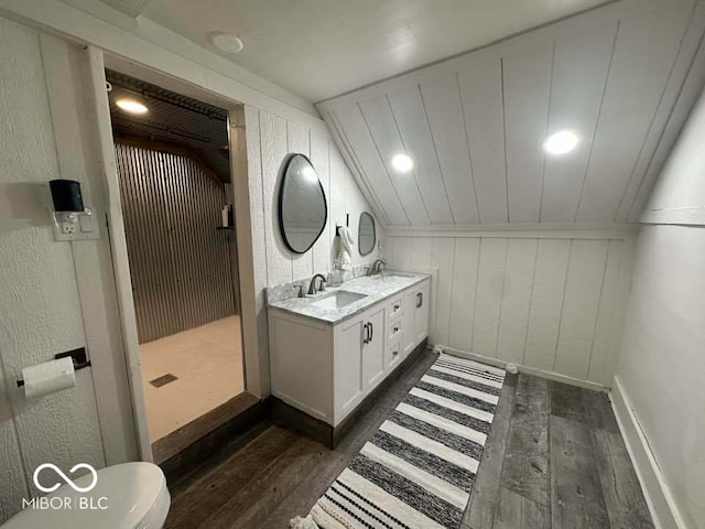 bathroom featuring hardwood / wood-style floors, wood walls, lofted ceiling, and walk in shower