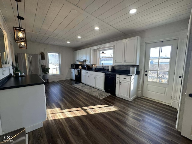 kitchen featuring black appliances, a healthy amount of sunlight, white cabinets, and pendant lighting