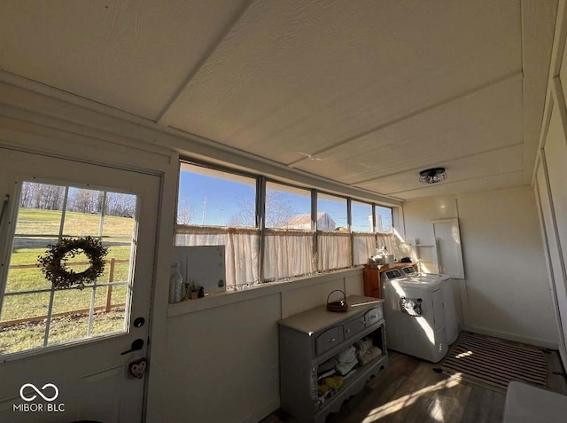 sunroom / solarium with a wealth of natural light and washer / dryer