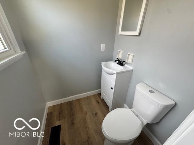 bathroom featuring hardwood / wood-style flooring, vanity, and toilet