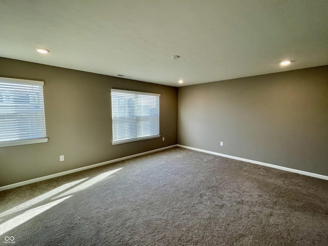 empty room featuring carpet and plenty of natural light