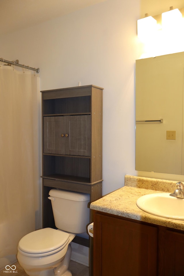 bathroom featuring vanity, toilet, and curtained shower