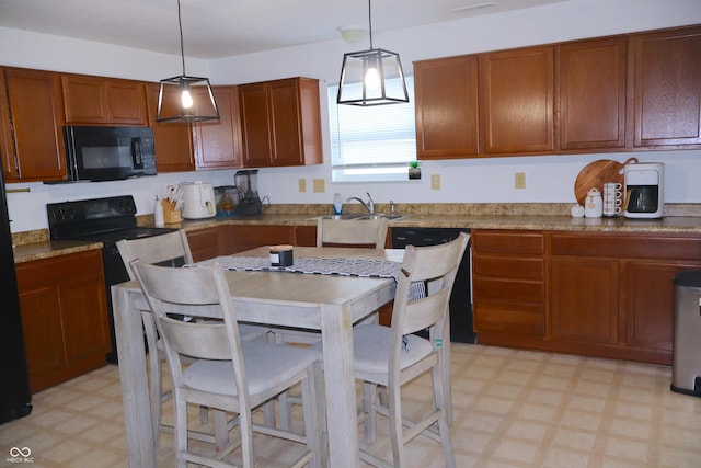 kitchen with electric stove, sink, and hanging light fixtures