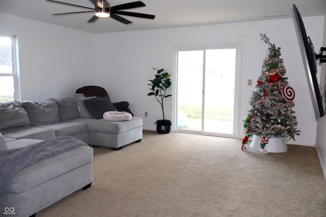 carpeted living room with ceiling fan