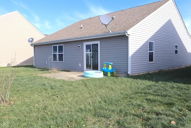 rear view of house with a patio area and a yard