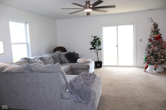 carpeted living room featuring ceiling fan