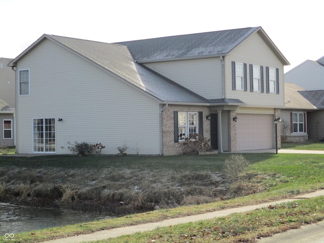 view of front of home featuring a garage and a front lawn