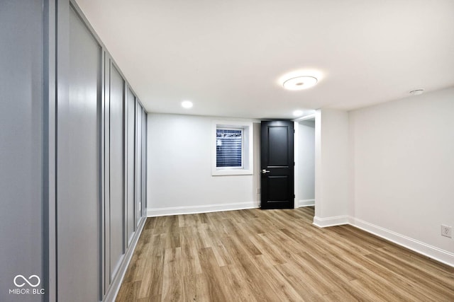 basement with light hardwood / wood-style flooring