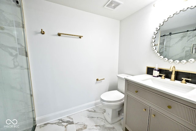 bathroom featuring vanity, toilet, and a shower with door