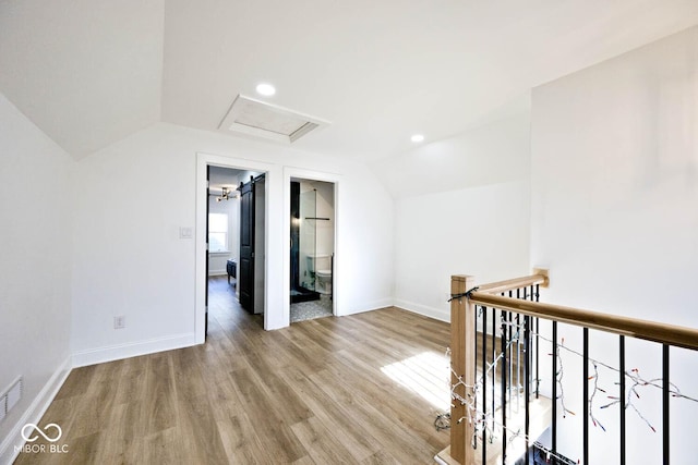 interior space with lofted ceiling and light wood-type flooring