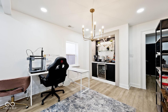 office area featuring hardwood / wood-style flooring, beverage cooler, and an inviting chandelier