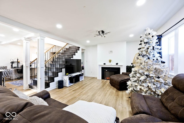 living room featuring hardwood / wood-style floors and decorative columns